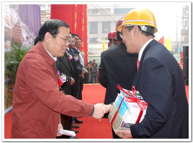 郑州市建委主任、书记郭庆宽向建筑职工代表发放创建文明城市的宣传物品
